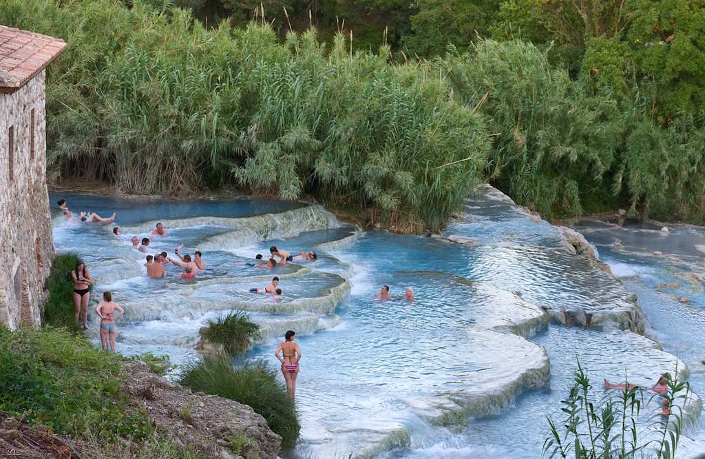 White natural travertine thermal waterfalls with sulphurous water in the Tuscan countryside